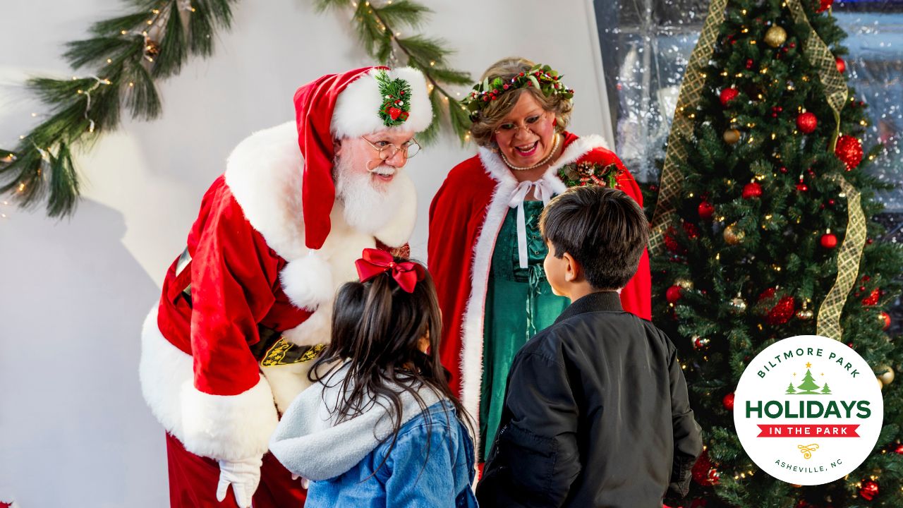 Two children meeting Santa Claus and Mrs. Claus at Biltmore Park's Santa in the Square event, one of many things to do in Asheville this holiday.