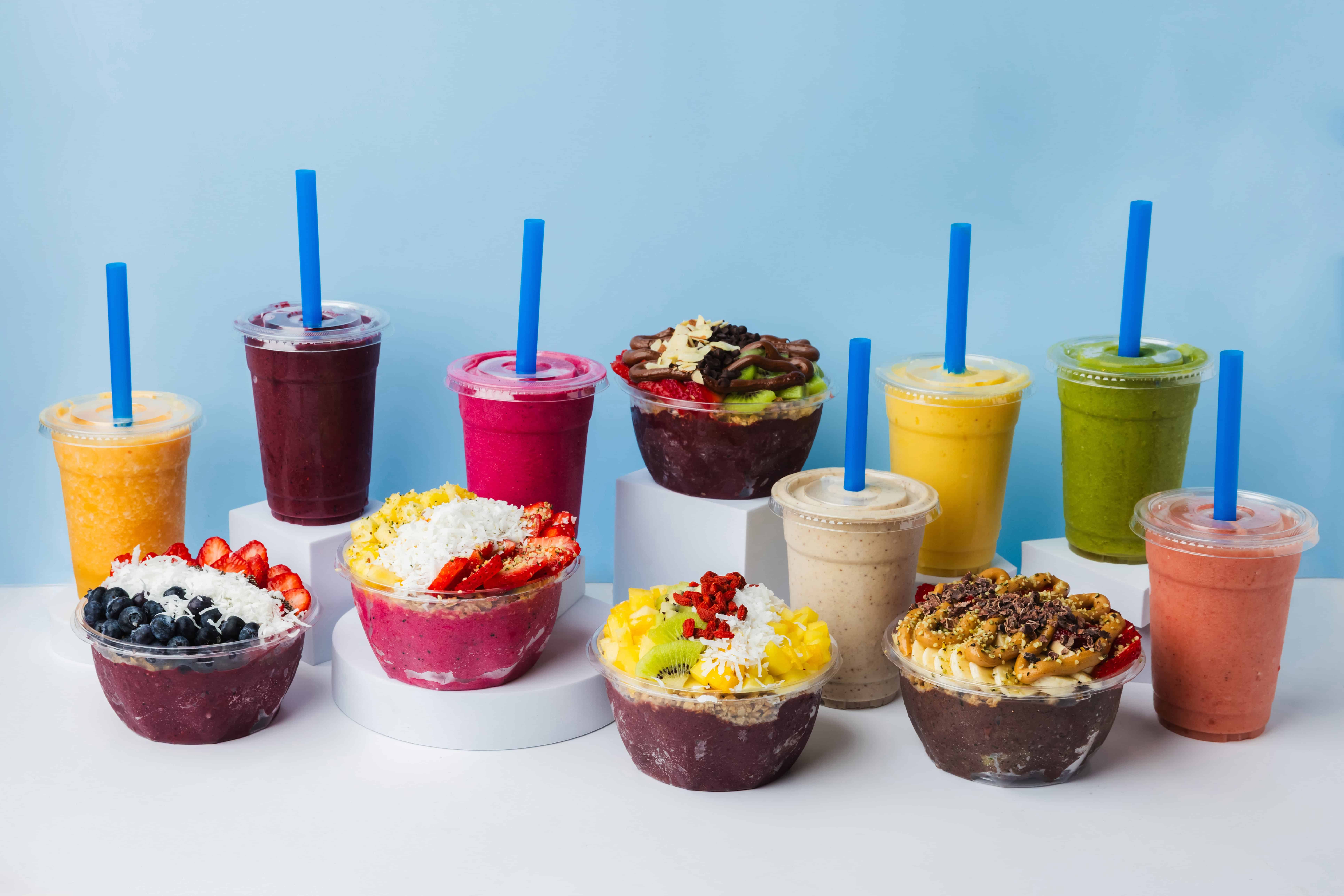 Palm Berries' colorful açaí bowls and smoothies with blue background.