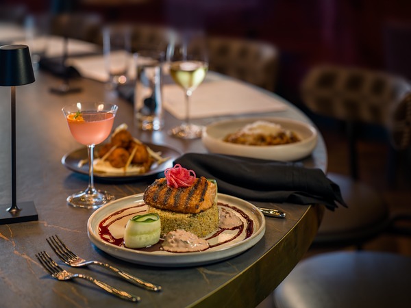 Two plates are set with entrees at Posana Biltmore Park.